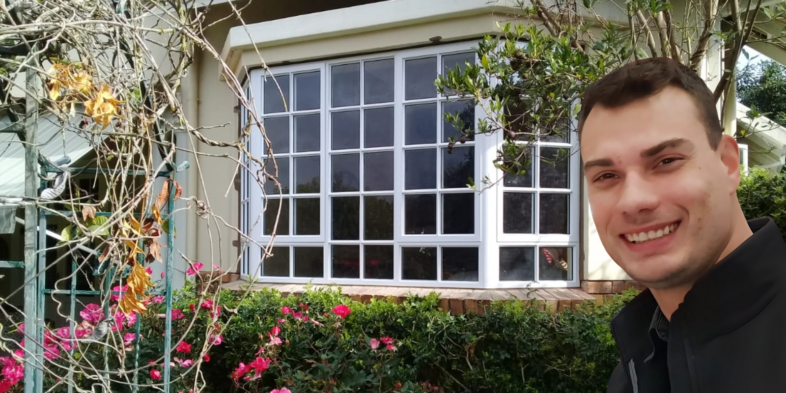 Justin, owner of Just Fit Aluminium, standing in front of aluminum windows he installed